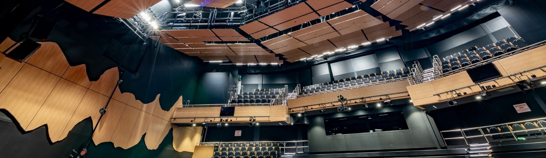 Unique use of customised decorative and slatted panels used in school theatre