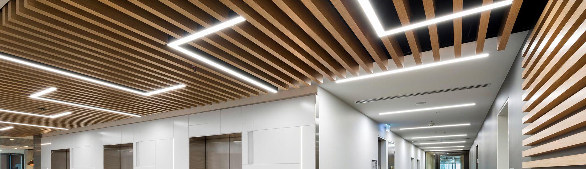 Matched Lightweight MAXI BEAM Ceiling and SUPASLAT Slatted Wall in Lift Lobby