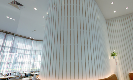 Curved column lined with Supaslat slatted acoustic panels