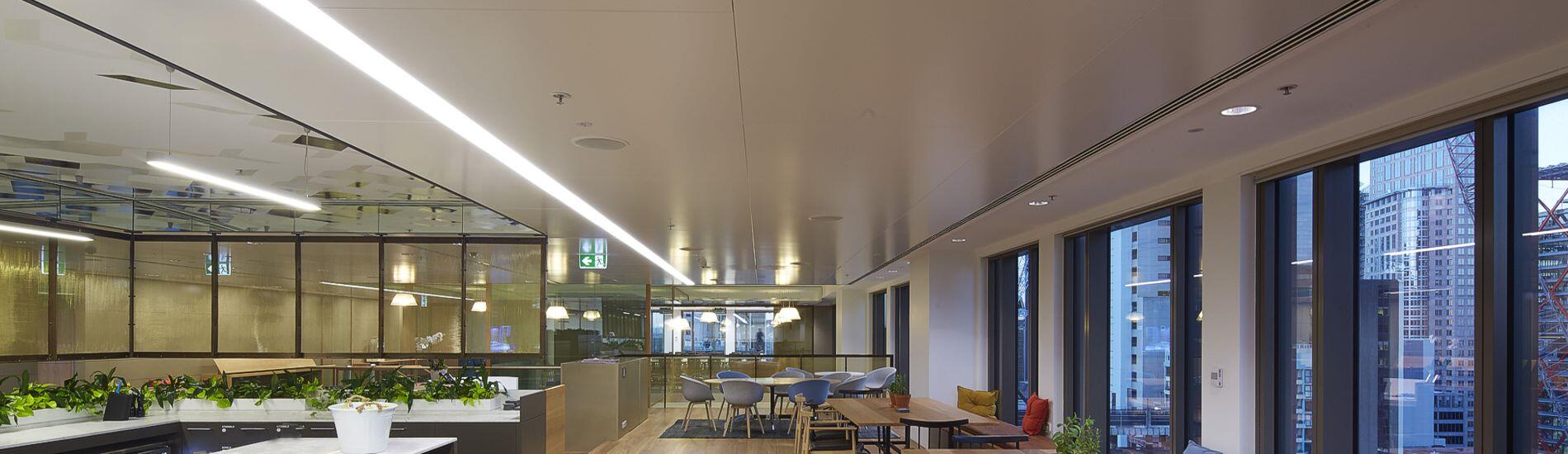 SUPALINE Decorative Ceiling Panels Help Reflect LIght Throughout Vast Area of Workplace