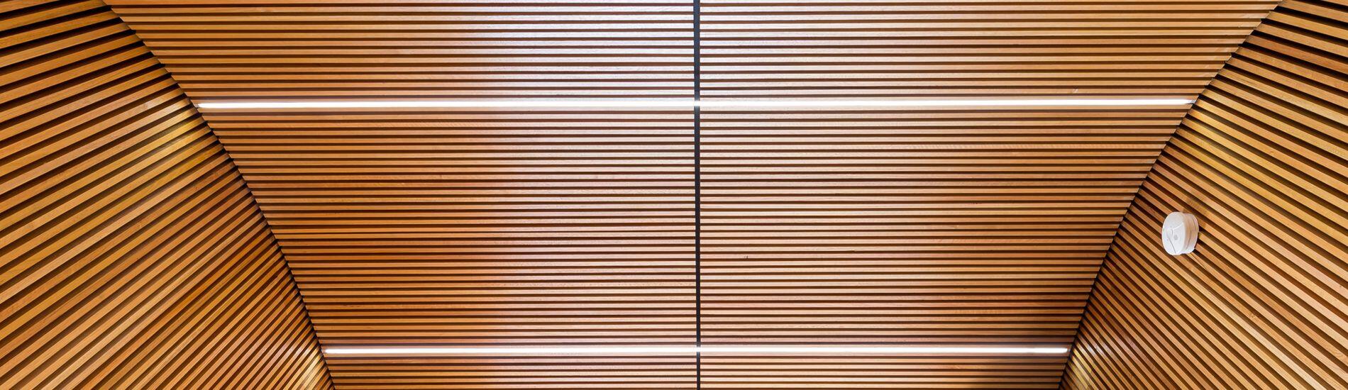 Dramatic SUPASLAT Slatted Wall and Curved Ceiling Panels Transform Entry in Building Refurbishment