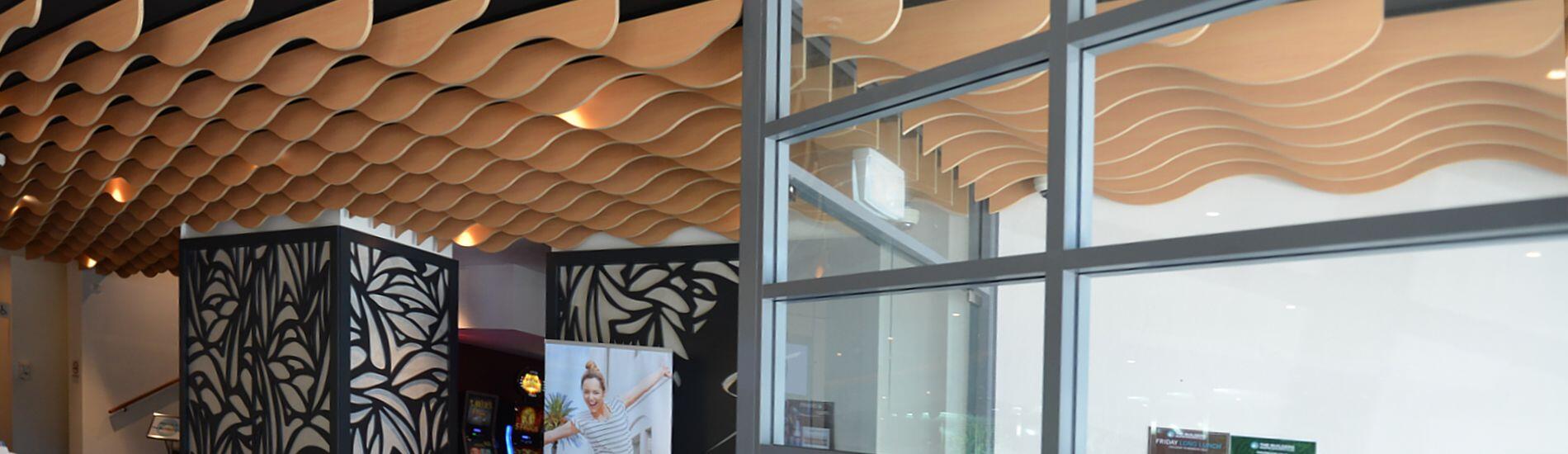 Timber WAVE BLADES Create Ripple Effect Ceiling Flowing Through Club Entry